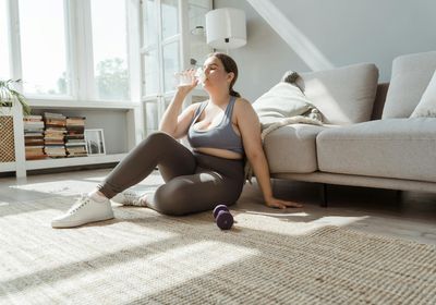 Close-up on comfortable sportswear and a water bottle on the floor.